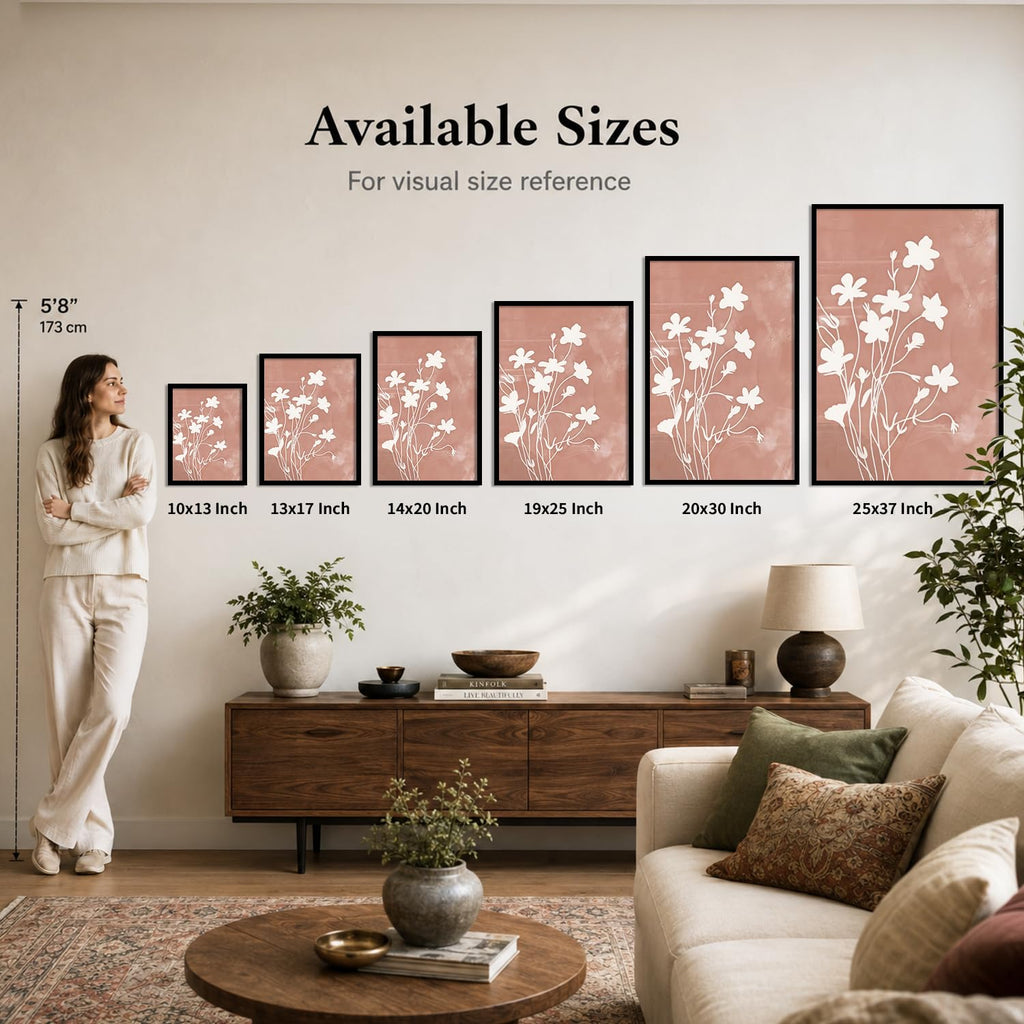 A lifestyle room scene showing a woman standing beside a row of framed floral wall art prints with text reading 'Available Sizes' and size labels from 10x13 inch to 25x37 inch. The room includes a sofa, console table, lamp, plants, and rug.