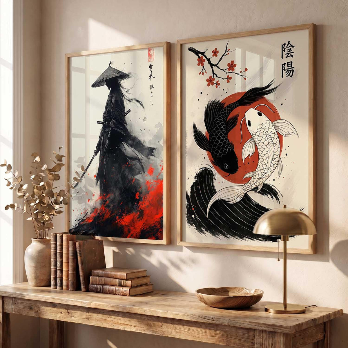 Two framed vertical wall art prints hang above a wooden console table in a styled interior. The left print shows a black ink-style figure with a conical hat on an off-white background with red accents.