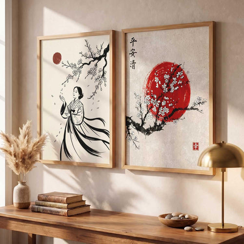Two framed vertical wall art prints hang on a beige wall above a wooden console table. The left print shows a black ink-style figure under a red sun with flowering branches; the right print shows a large red moon with white blossoms and Chinese characters.