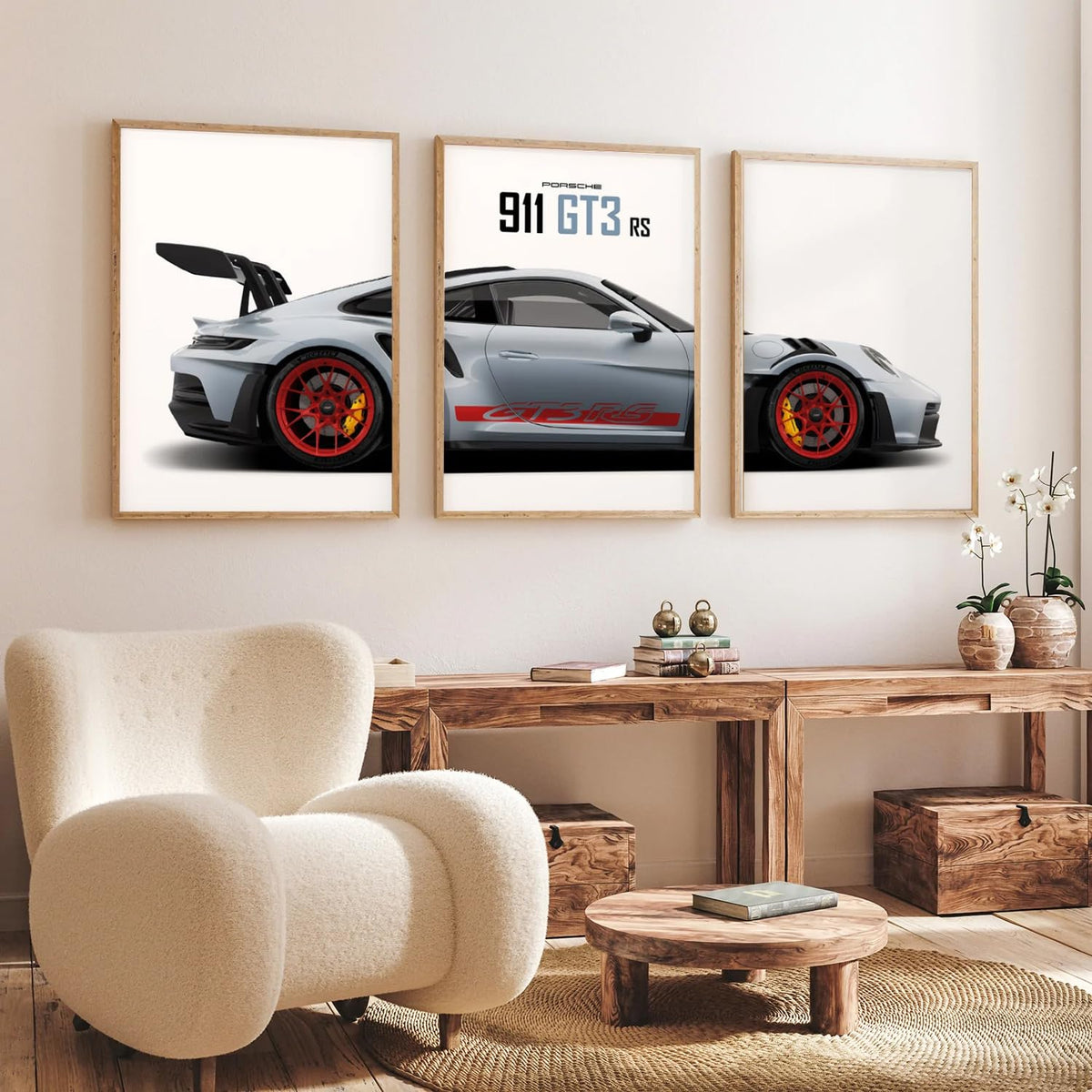 A three-panel framed wall art set showing a silver Porsche 911 GT3 RS, displayed in a modern living room setting above a wooden console table and a cream-colored armchair.